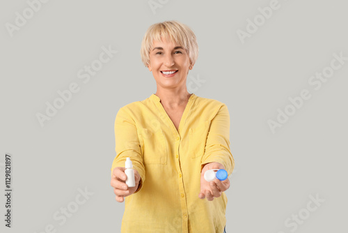 Mature woman with eye drops...