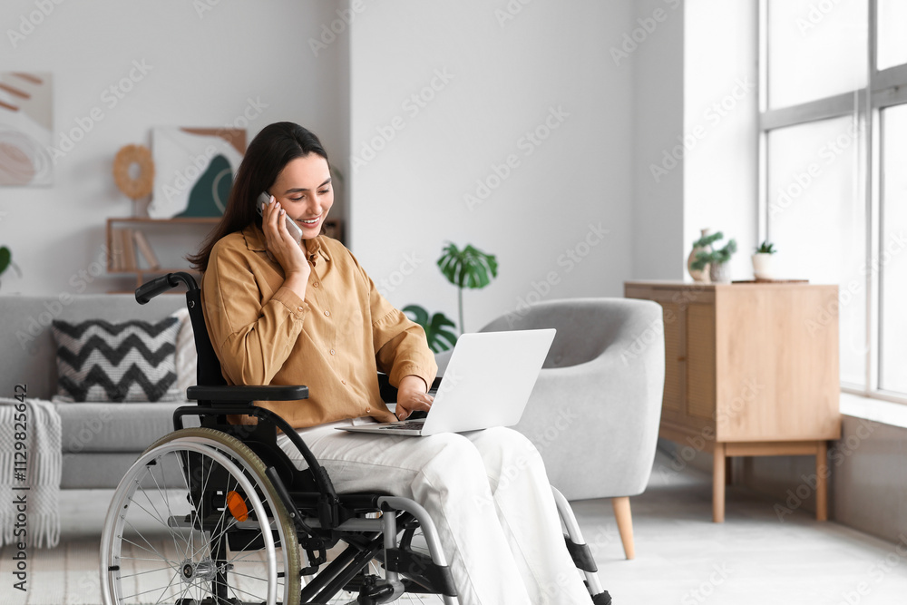 Young woman in wheelchair with laptop talking by mobile phone at home Young woman in wheelchair with laptop talking by mobile phone at home