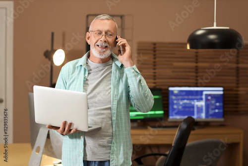 Mature programmer working w...