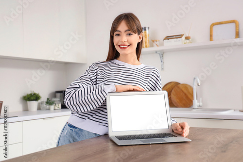 Young woman with blank lapt...