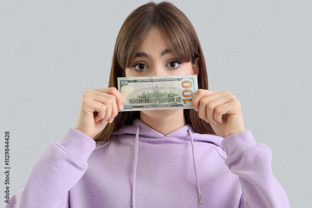 Young woman with dollar banknote on light background, closeup Young woman with dollar banknote on light background, closeup