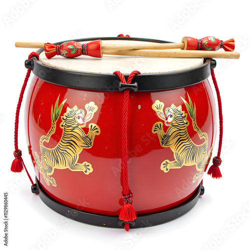 A colorful asian drum adorned with tiger artwork and decorative sticks for cultural celebrations, photography of still life concept. photo