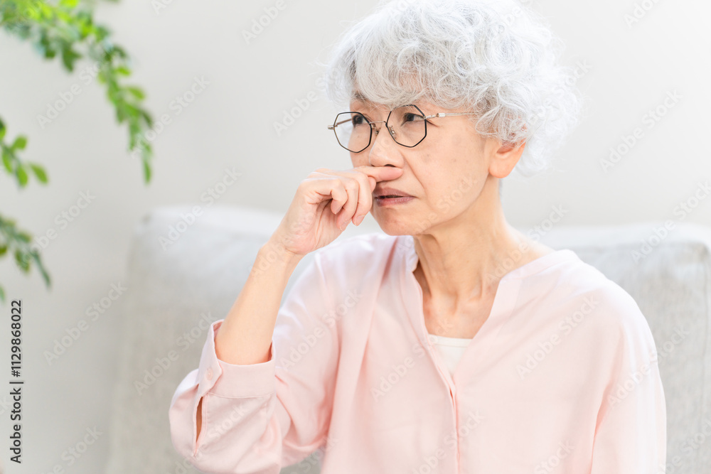 鼻づまりを起こしているシニア女性 鼻づまりを起こしているシニア女性