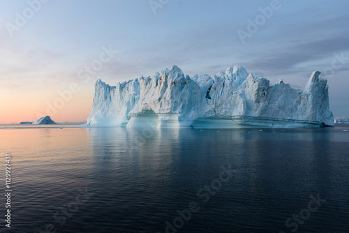 Serene Image of an Iceberg in the Early Morning on Water photo