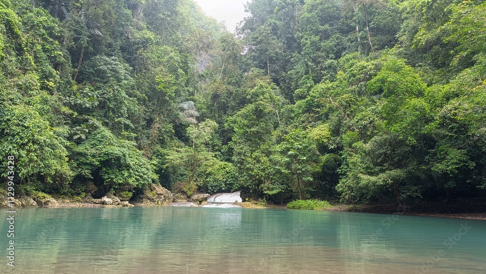Fototapeta premium Natural scenery: trees, waterfalls, sky and blue-green river water