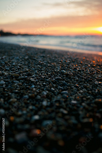 sunset on the beach focused on pebbles