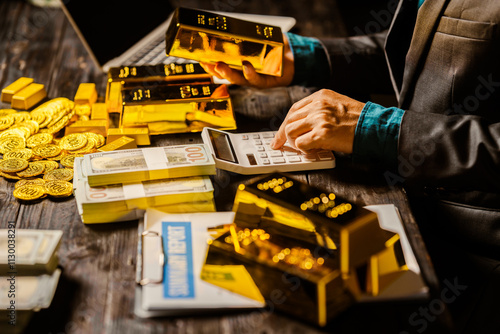 Wallpaper Mural A businessman sits at his desk in a nighttime office, using a laptop to analyze gold bar prices,exchange rates, and investment plans in gold trading, mining,and the stock market amid price increases Torontodigital.ca