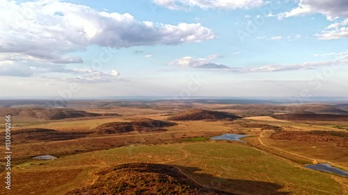 Clouds flying over hilly landscape in South African countryside, high timelapse photo