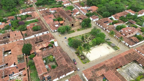 Aerial estabilshing pan of Guane historic square surrounded by colonial buildings, cobblestone streets, Colombia photo