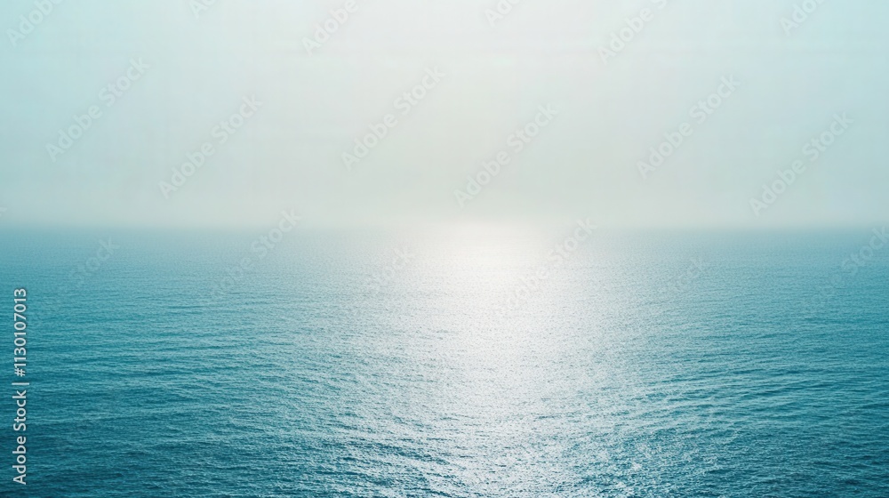 Fototapeta premium Serene Ocean Surface Under a Hazy Sky