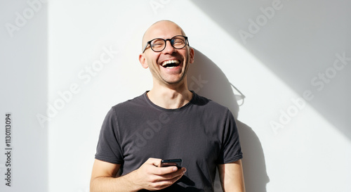 A smiling bald man wearing ...