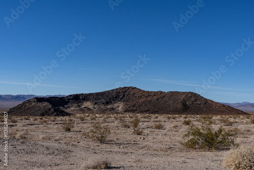 A cinder cone (or scoria cone) / Basalt Flow / volcano. U.S. Route 66 or U.S. Highway 66 / National Trails Hwy, Bagdad,  San Bernardino County, California.  Mojave Desert / Basin and Range Province. 
