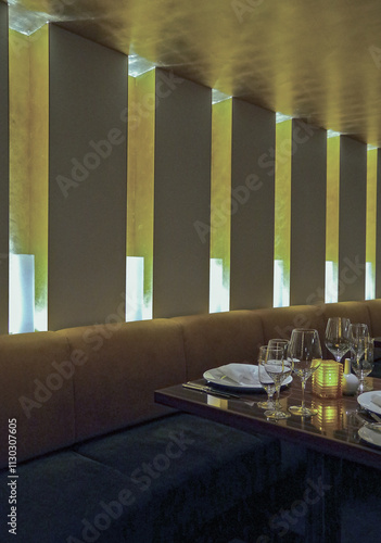 Formal and elegant Art Deco steak house dining room restaurant onboard luxury cruiseship or cruise ship liner with set tables in classic interior design style and ceiling ambient lighting photo