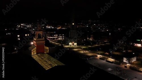 Wallpaper Mural Stunning aerial footage of Kristiansand Domkirke illuminated at night. The cathedral stands tall amidst the city lights, creating a captivating contrast. Establishing shot 4k Torontodigital.ca