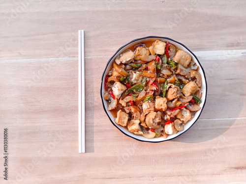 stir-fried knuckle or trotter with tofu served with plate on wooden background. chewy and soft dish. asian cuisine. oseng tahu kikil photo