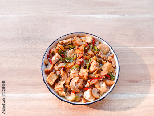 stir-fried knuckle or trotter with tofu served with plate on wooden background. chewy and soft dish. asian cuisine. oseng tahu kikil photo