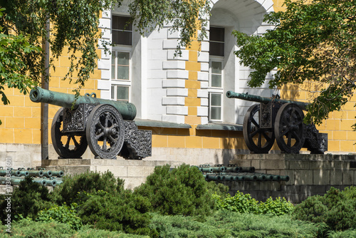 Ancient cannons are installed on territory of Moscow Kremlin. Guns are made of copper. Color of gun barrels is green. Clear sunny summer day. Moscow, Russia – June 14, 2024