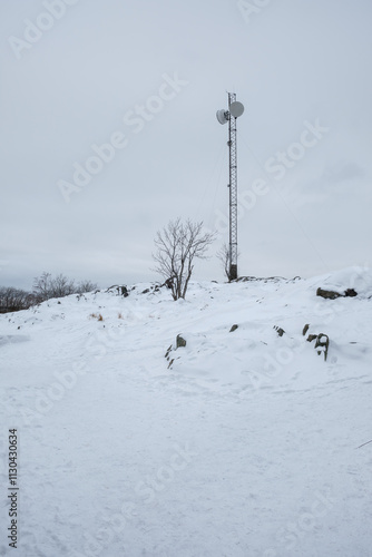 Snow-covered landscape with communication tower in winter Stockholm, Sweden