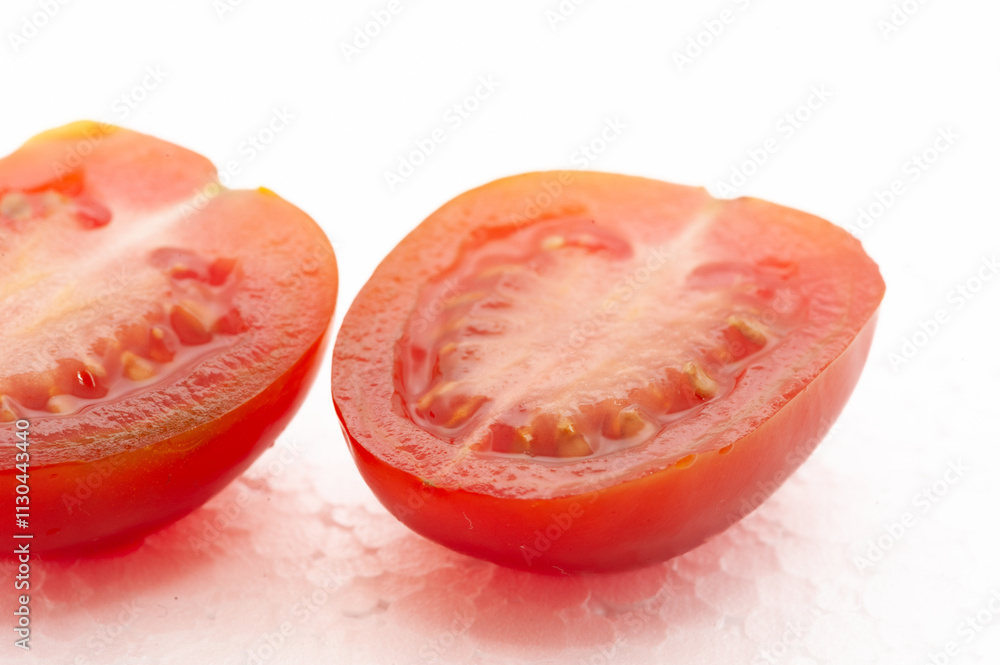 Two tomato slices are cut in half Two tomato slices are cut in half