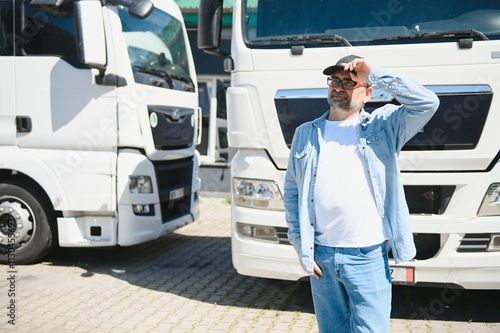 Senior man walking in front of his truck photo