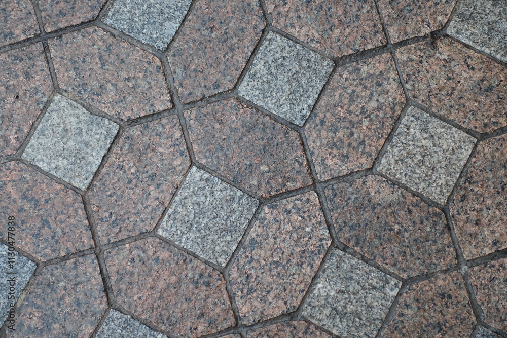 Obraz premium Macro of wet red and grey unpolished granite pavement