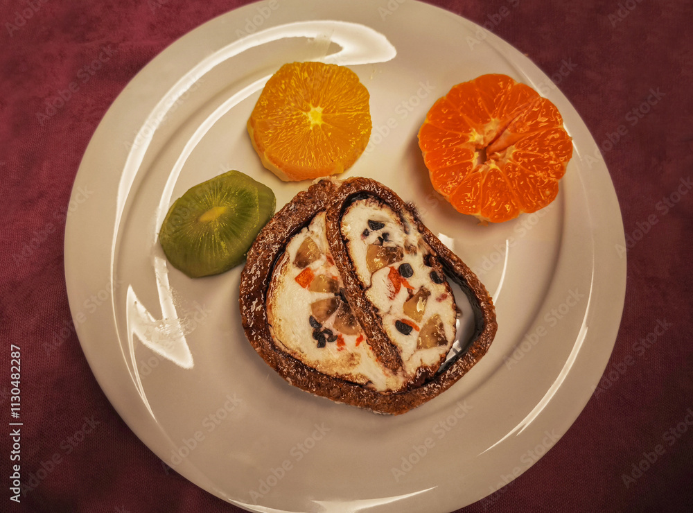 Fig dessert with ice cream and fruit. Tangerine, orange, kiwi.