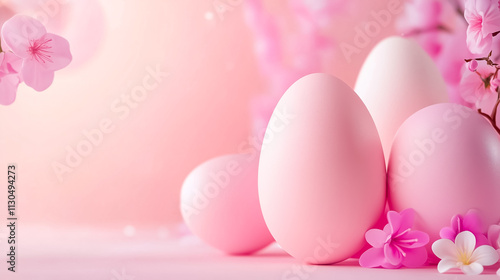Delicate pastel pink eggs nestled among blooming cherry blossoms create a tranquil scene full of springtime charm