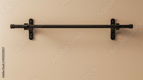 A pull-up bar mounted on a solid beige background. photo