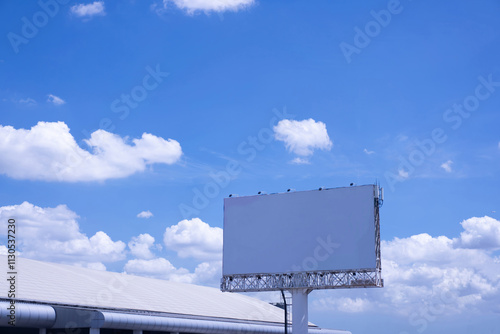 Large empty blue billboard on morning sky background