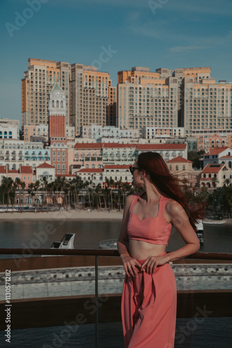 Young woman in a pink suit against the backdrop of Sunset Town in Vietnam