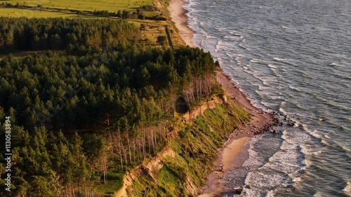 Breathtaking coastal cliffs of Baltic sea at Jurkalne, Latvia at sunset, aerial photo