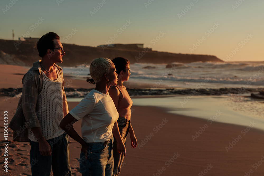 Fototapeta premium Friends enjoying golden hour sunset on beach together