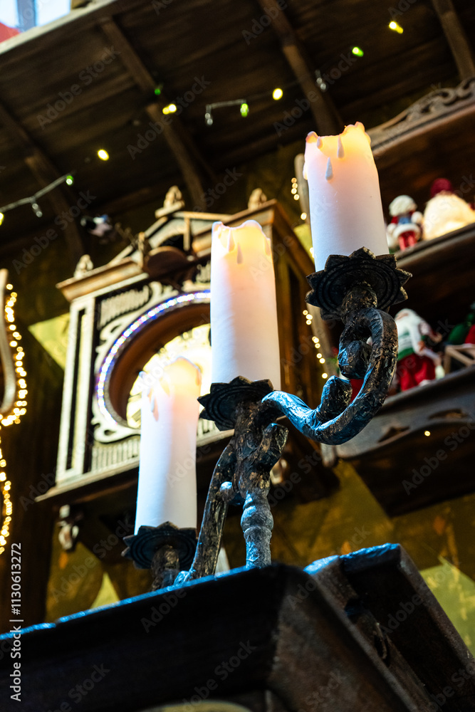 Naklejka premium A huge candlestick and candles on it. 3 candles on a candlestick, New Year