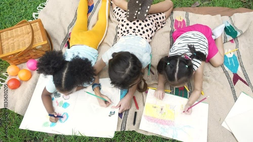 Happy Diverse Kids painting in the garden