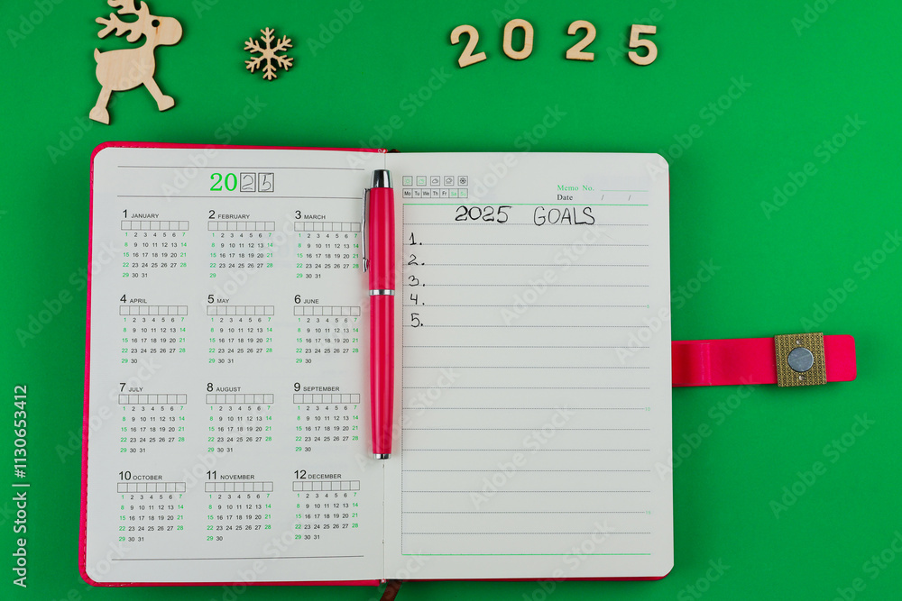 A pink banknote diary with a pink handle lies in the foreground, the ...