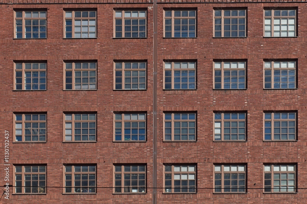 Fototapeta premium Windows on a red brick wall.