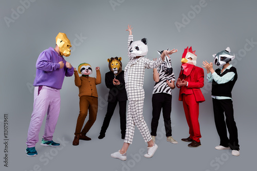 Full body portrait of zebra gorilla raccoon lion sloth rooster mask people applaud dancing panda isolated on grey color background photo