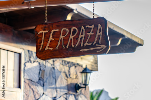 Spanish Terraza sign hanging from the ceiling with arrow pointing to the right