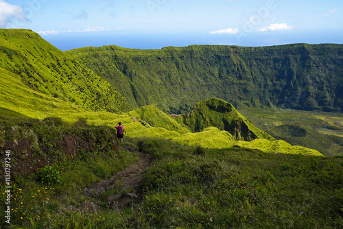 A mountaineer on a hiking trail the caldera on the Azores island Faial.