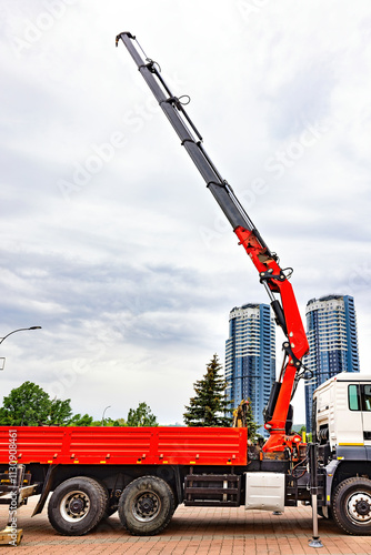 Obraz na płótnie Towering crane reaches towards the cloudy sky above a busy urban construction site w salonie