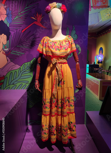 A long women's dress with a multicolored floral pattern on a mannequin