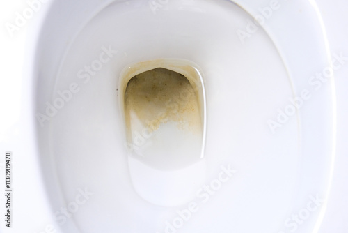 Dirty unhygienic toilet bowl with limescale stain at public restroom close up.