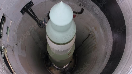 Vertical panning shot of minuteman nuclear missile in underground silo