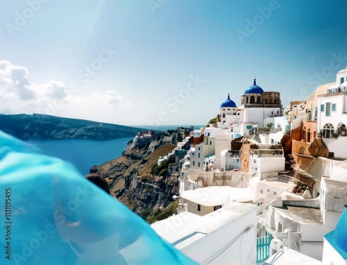 A girl's blue scarf blowing in the wind in Santorini