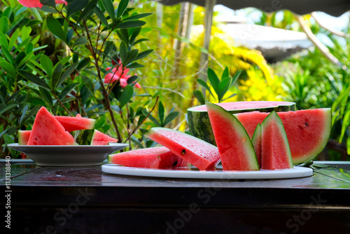 Slices of ripe watermelon on wooden table close up