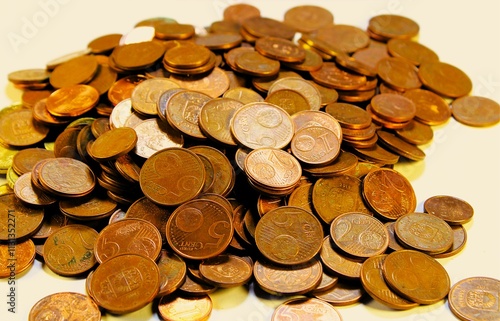 a large pile of small denomination euro coins on a white background