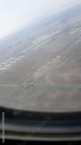 Aerial view of the city of Tehran, Imam Khomeini Airport, Parand Industrial Town, and various areas during takeoff from the plane window