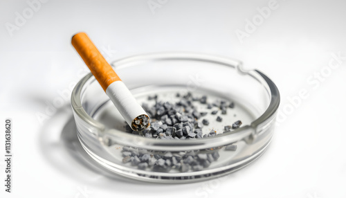 cigarette and an ashtray on white background. the cigarette is on the ashtray. Yellow filter. Harm to health. It a bad habit. The vision of world without tobacco, tobacco and lung health. Lung cance photo