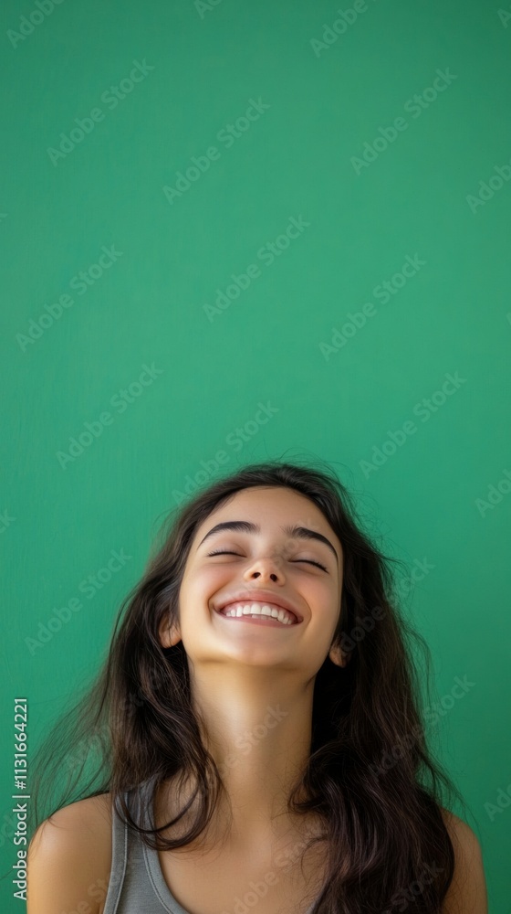 Fototapeta premium beautiful girl beautiful young woman smiling on green background with copy space vertically 9:16
