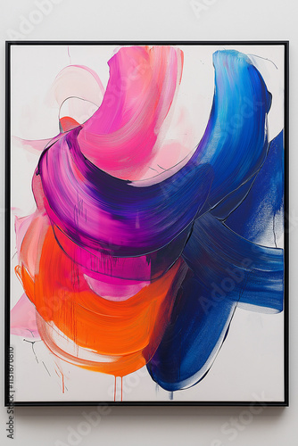 Photographie d'un tableau abstrait avec couleurs vives et formes dynamiques, encadré dans un cadre noir simple, sur fond blanc